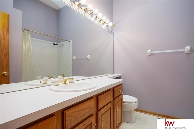 bathroom with a shower with shower curtain, toilet, vanity, and tile patterned floors