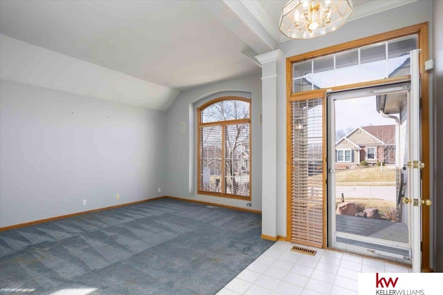 entrance foyer with visible vents, a notable chandelier, carpet, baseboards, and vaulted ceiling