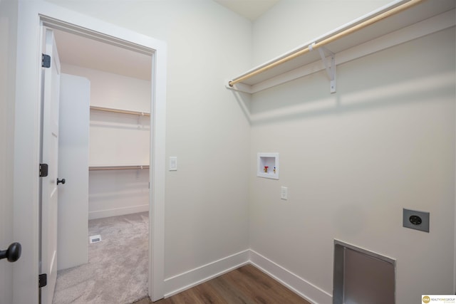 laundry room with hookup for a washing machine, laundry area, dark wood-type flooring, baseboards, and electric dryer hookup