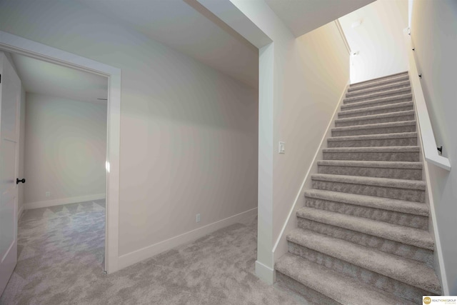 stairs with carpet floors and baseboards