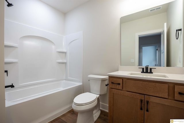 bathroom with visible vents, toilet, shower / tub combination, wood finished floors, and vanity