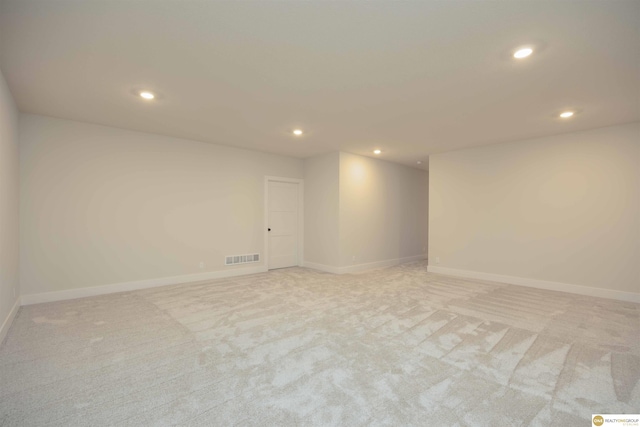 spare room featuring visible vents, baseboards, light colored carpet, and recessed lighting