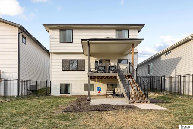 back of property with central air condition unit, a fenced backyard, stairway, and a yard