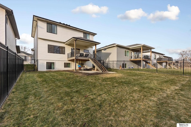 rear view of house with stairs, a lawn, and a fenced backyard