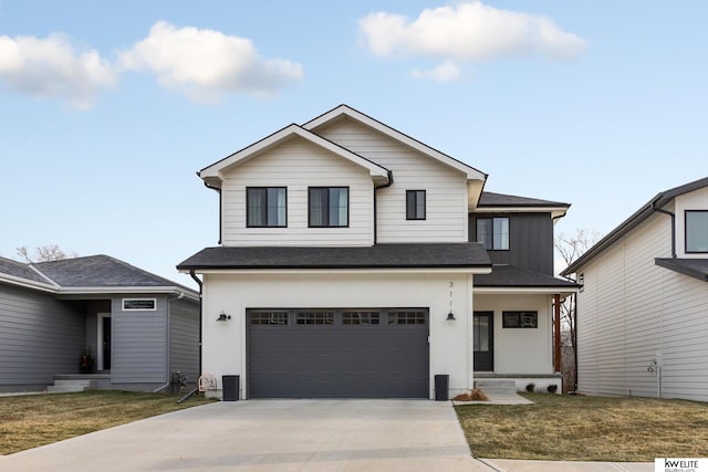 view of front of property with driveway, a shingled roof, a garage, and a front yard