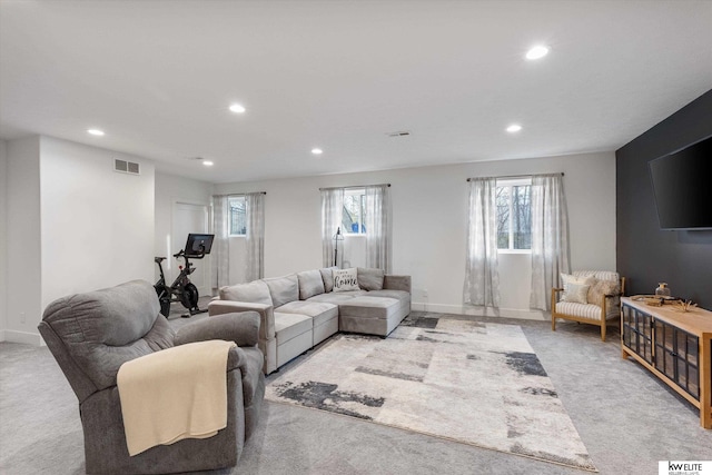 living room featuring light carpet, baseboards, visible vents, and recessed lighting