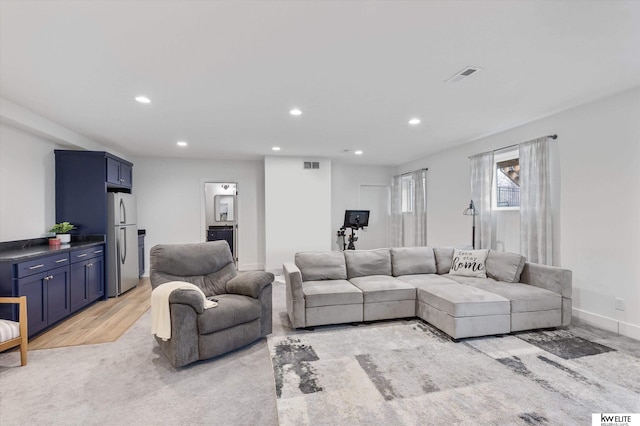 living room featuring recessed lighting, visible vents, light wood-style flooring, and baseboards