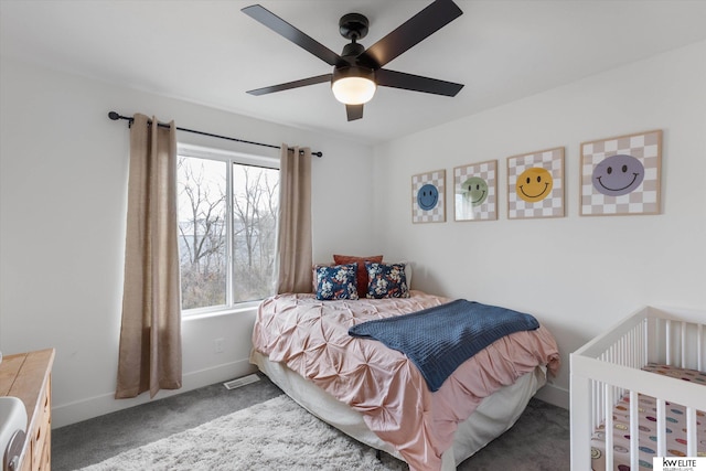 carpeted bedroom featuring ceiling fan, visible vents, and baseboards