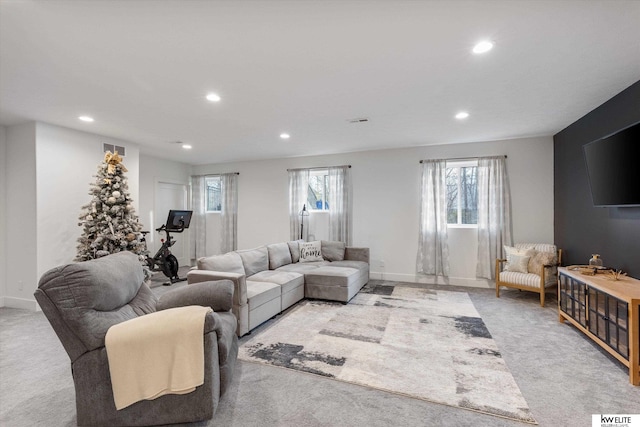 living area with recessed lighting, visible vents, and light colored carpet