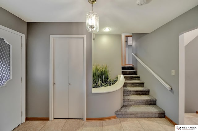 stairs with tile patterned flooring and baseboards