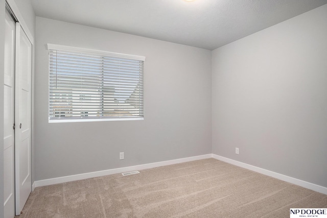 unfurnished bedroom featuring carpet, a closet, and baseboards