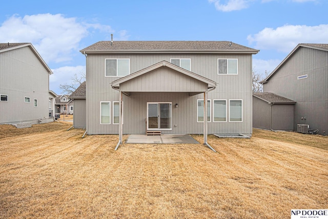 back of house with a yard, roof with shingles, a patio, and central AC unit