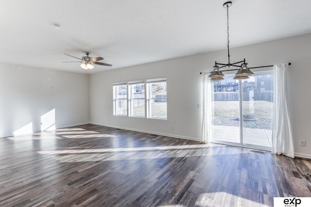 spare room featuring a ceiling fan, baseboards, visible vents, and dark wood-type flooring