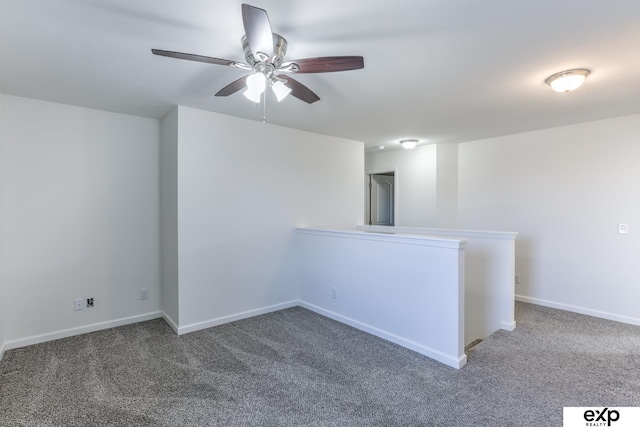 spare room with ceiling fan, baseboards, and carpet flooring