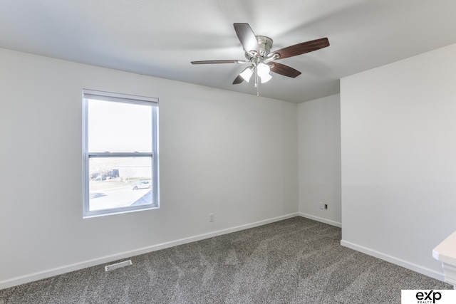 carpeted empty room with visible vents, baseboards, and ceiling fan