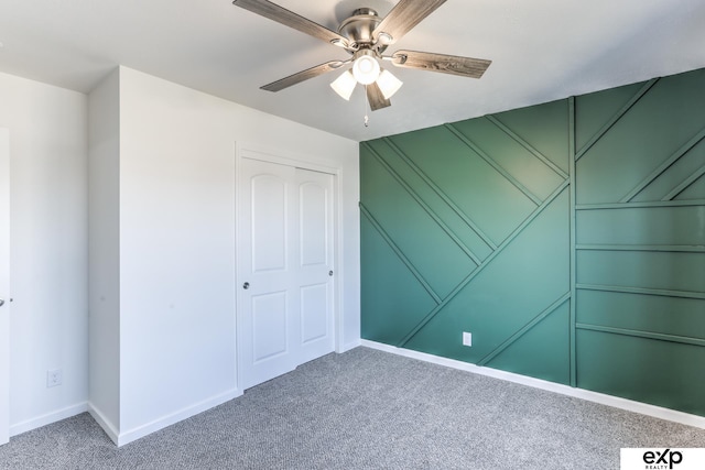 unfurnished bedroom featuring a ceiling fan, a closet, carpet flooring, and baseboards