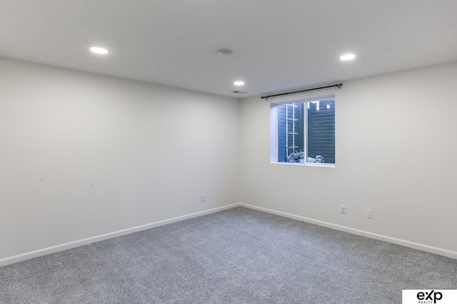 carpeted spare room with recessed lighting, visible vents, and baseboards