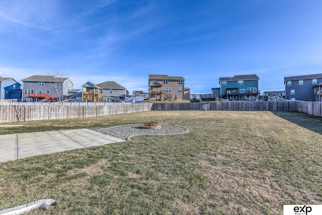 view of yard with a residential view, a patio area, and a fenced backyard