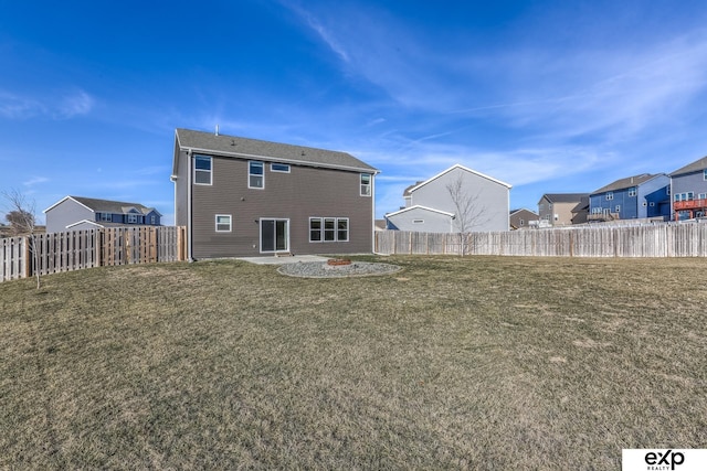 back of house featuring an outdoor fire pit, a fenced backyard, and a yard