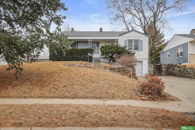 single story home with a garage, stairs, and concrete driveway