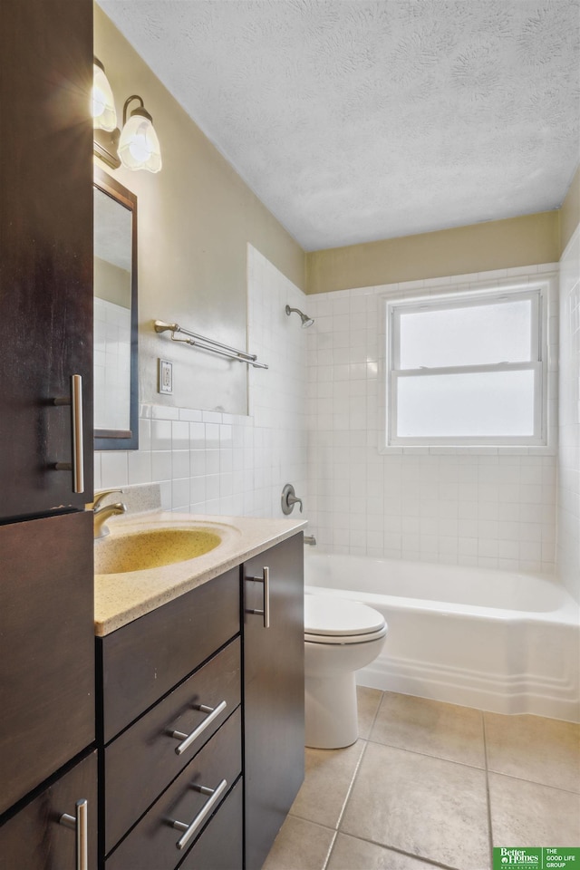 bathroom with tile walls, bathtub / shower combination, toilet, a textured ceiling, and tile patterned floors