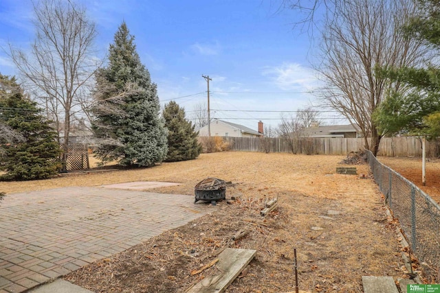 view of yard with an outdoor fire pit, a patio area, and fence private yard