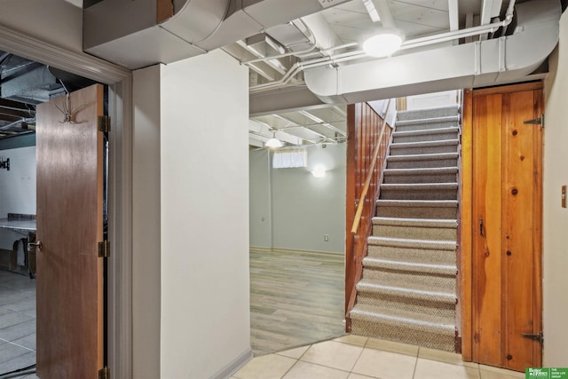 basement with stairs and tile patterned floors