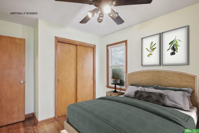 bedroom featuring a closet, wood finished floors, a ceiling fan, and baseboards