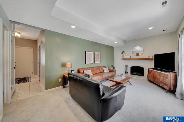 living room featuring light carpet, baseboards, visible vents, a brick fireplace, and recessed lighting