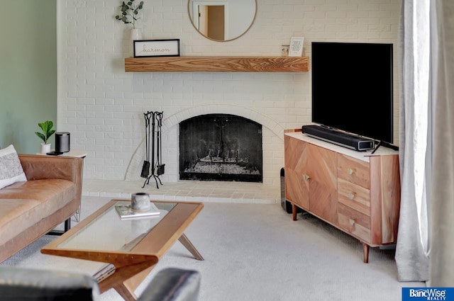 living area featuring carpet floors and a brick fireplace