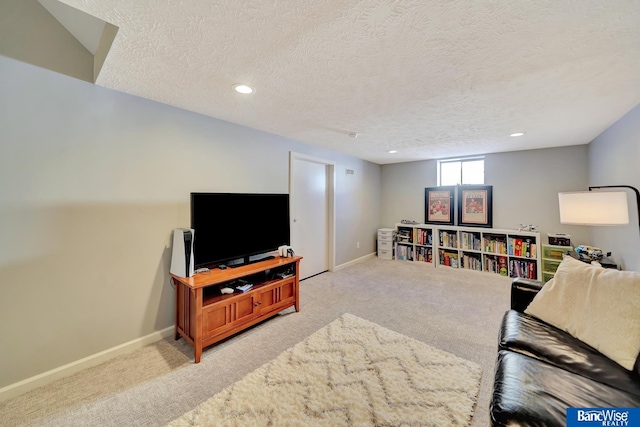 carpeted living area featuring a textured ceiling, recessed lighting, and baseboards