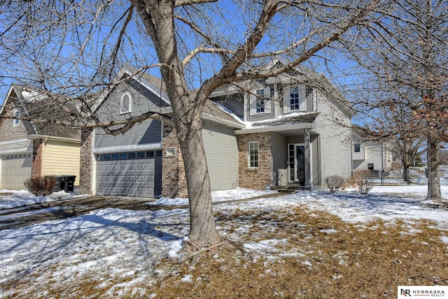 exterior space with brick siding, an attached garage, and fence