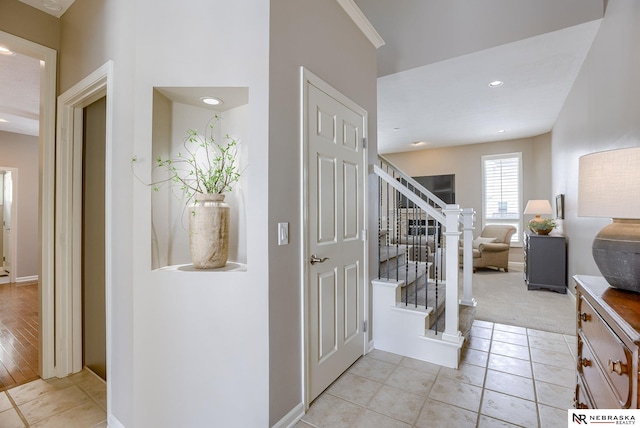 interior space featuring light tile patterned floors, stairway, and recessed lighting