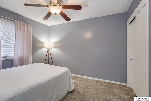 bedroom featuring ceiling fan, carpet floors, and baseboards