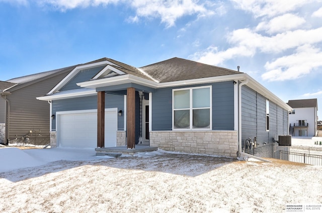 view of front facade with an attached garage, cooling unit, fence, stone siding, and roof with shingles