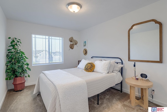 bedroom with baseboards and carpet flooring