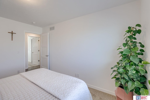 bedroom featuring baseboards, visible vents, and light colored carpet