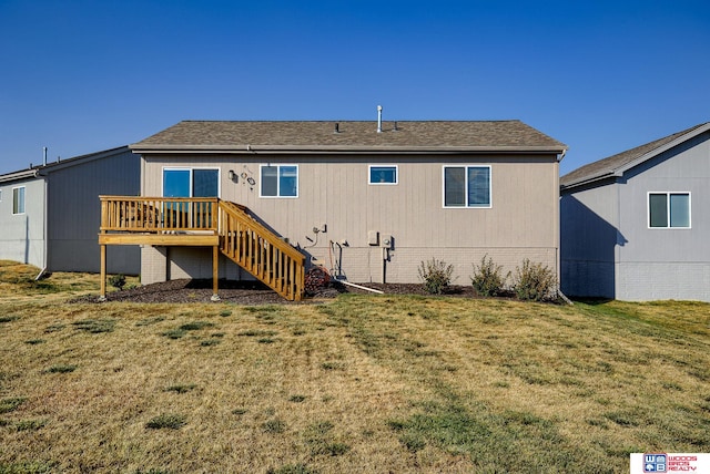 back of property with a yard, a wooden deck, stairs, and brick siding