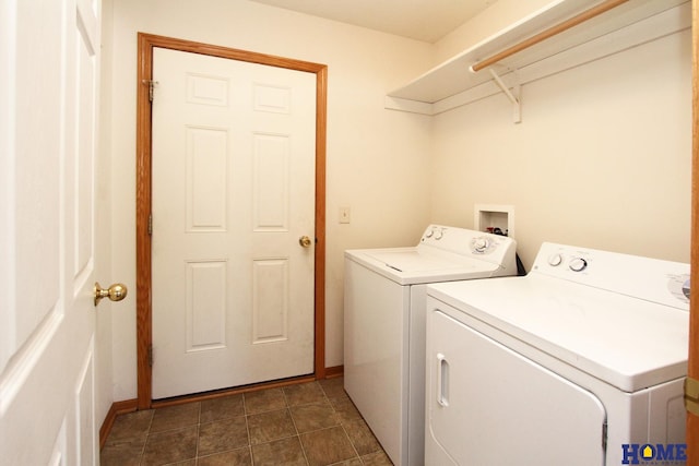 laundry area with laundry area, washer and clothes dryer, and baseboards