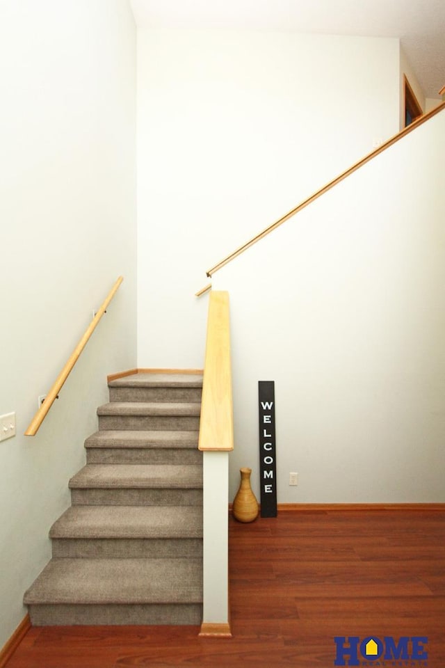 stairs featuring baseboards and wood finished floors