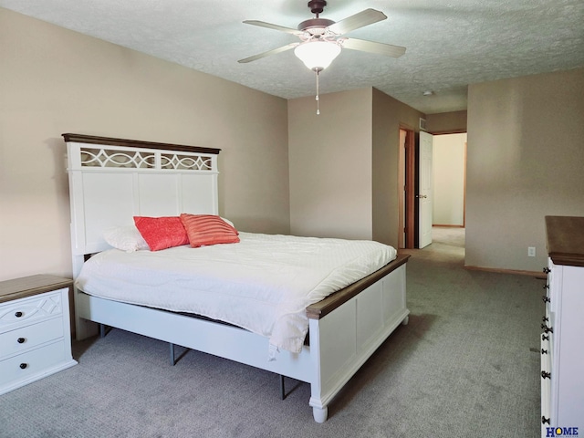 bedroom with a textured ceiling, carpet floors, ceiling fan, and baseboards