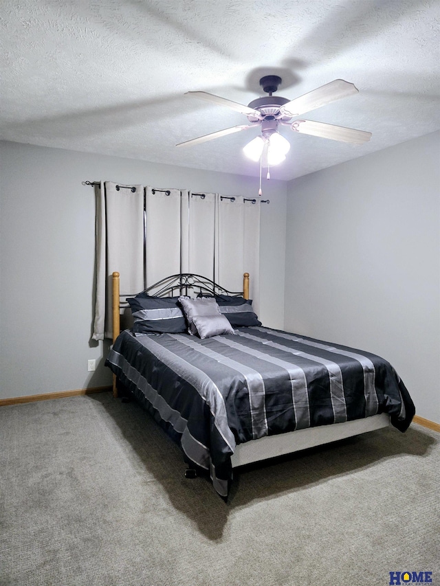 bedroom with a textured ceiling, carpet, a ceiling fan, and baseboards