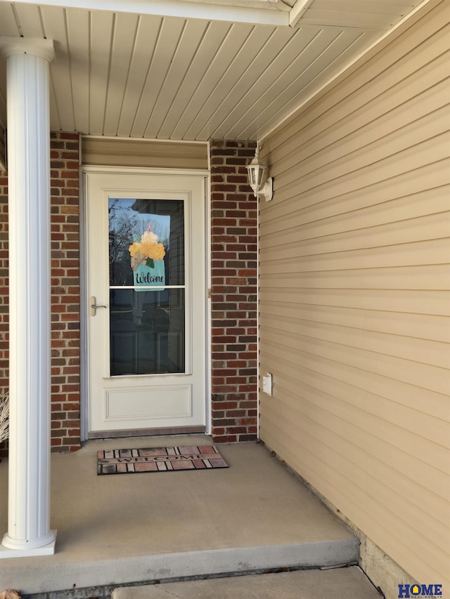 entrance to property with brick siding