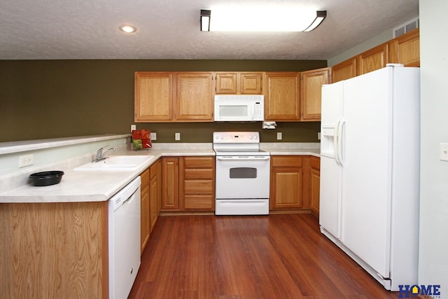 kitchen featuring light countertops, white appliances, visible vents, and a sink