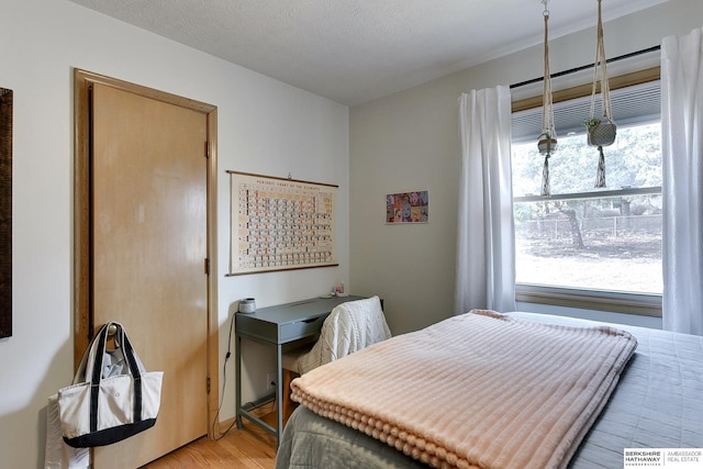 bedroom featuring a textured ceiling and light wood-type flooring