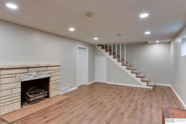 unfurnished living room with stairs, visible vents, and recessed lighting