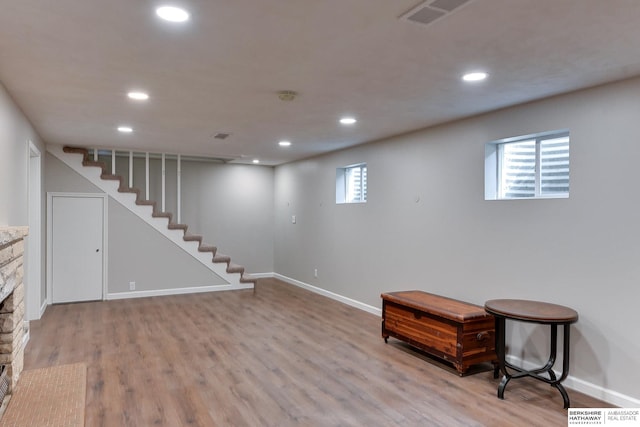 below grade area with stairs, wood finished floors, and recessed lighting