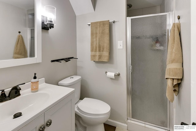 bathroom featuring a shower stall, toilet, and vanity