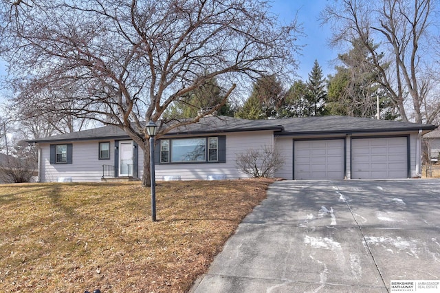 ranch-style house featuring an attached garage, driveway, and a front yard