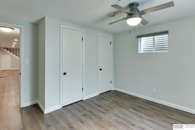 unfurnished bedroom featuring ceiling fan, wood finished floors, and baseboards